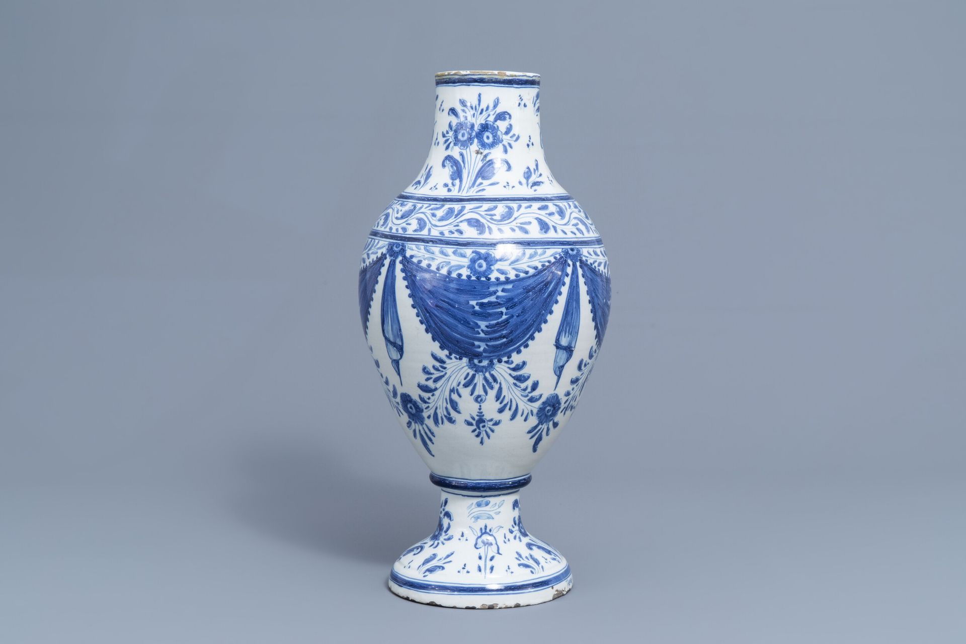 A Spanish blue and white pharmacy jar with floral design, Talavera, 19th C.