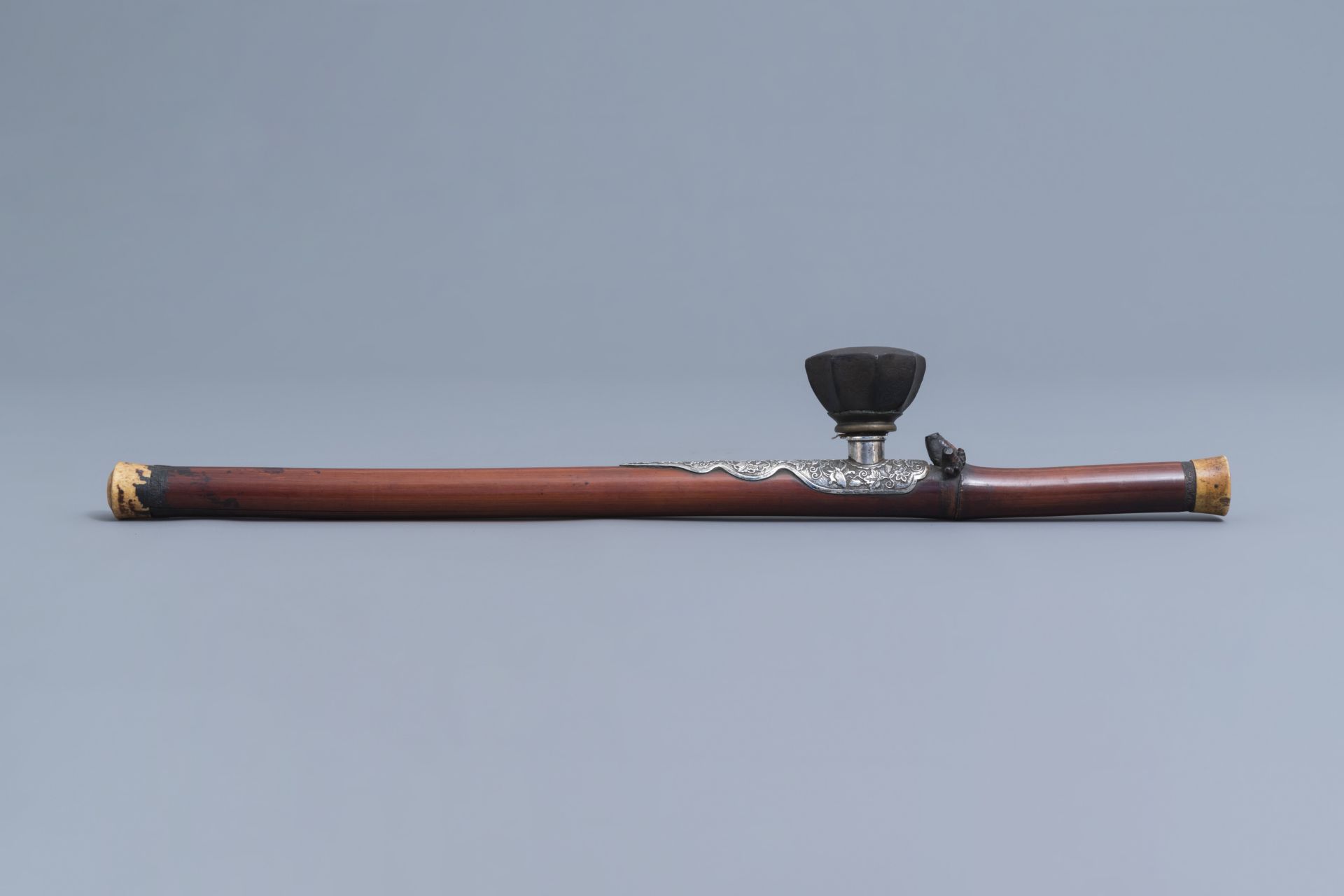 A Chinese bamboo opium pipe with a silver saddle, ivory endpiece and stoneware damper, 19th C. - Image 3 of 12