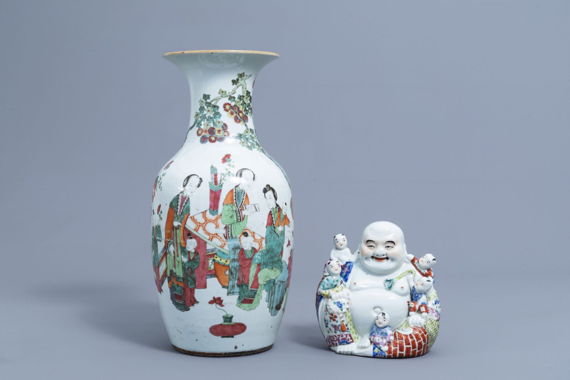 A Chinese famille rose figure of Buddha with children and a vase with figures, 19th/20th C.
