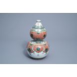 A Chinese famille verte double gourd vase with floral design and Buddhist symbols, 19th C.