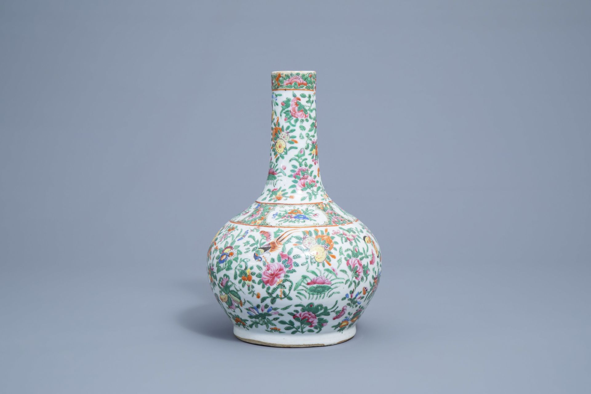 A Chinese Canton famille rose bottle vase with floral design, 19th C. - Image 4 of 7