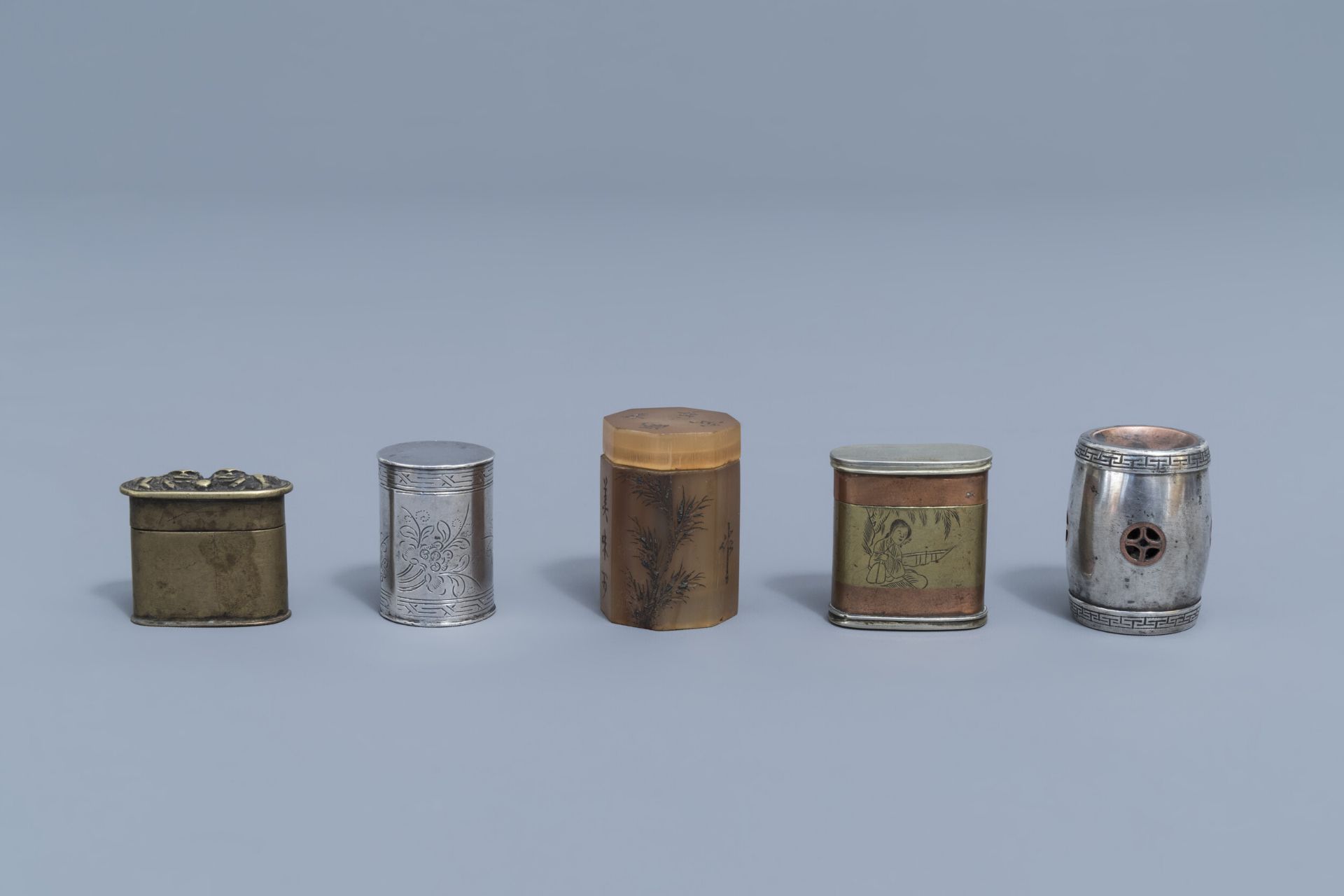 A collection of five silver, paktong, brass and horn opium boxes and covers, 19th/20th C.
