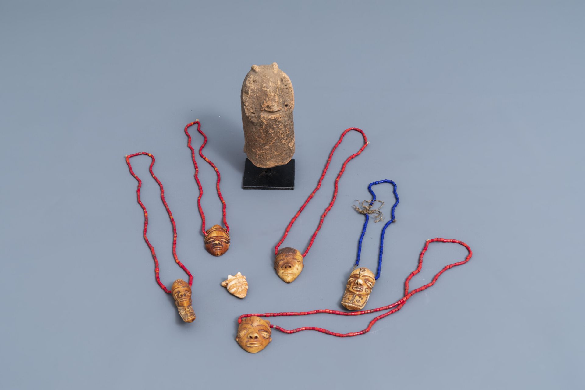 Six ivory Ikhoko pendants, Pende, Congo and a terracotta sculpture, Bura, Niger, 20th C.