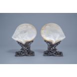 A pair of Chinese carved mother-of-pearl shells on wooden stands, 19th C.