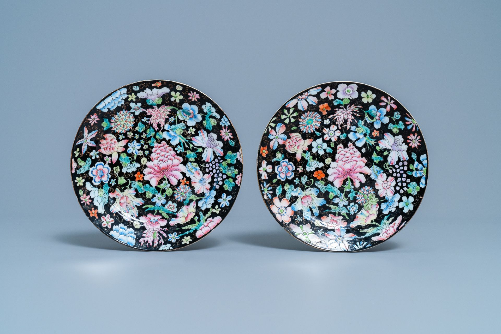 A pair of Chinese famille rose 'millefleurs' plates and a blue ground plate, 19th/20th C. - Image 2 of 5
