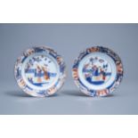 A pair of Chinese Imari style plates with figures in a garden, Kangxi