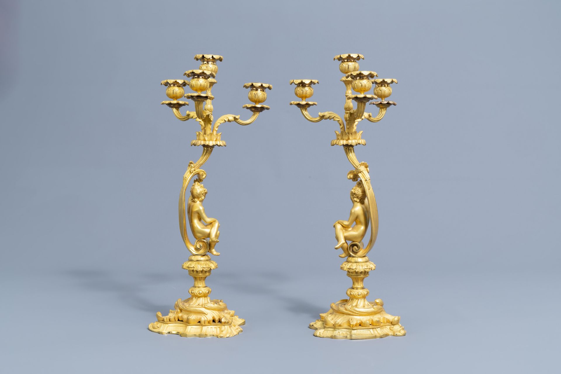 A French gilt bronze mounted Sevres style clock and a pair of Louis XV style candelabra, 19th C. - Image 19 of 23