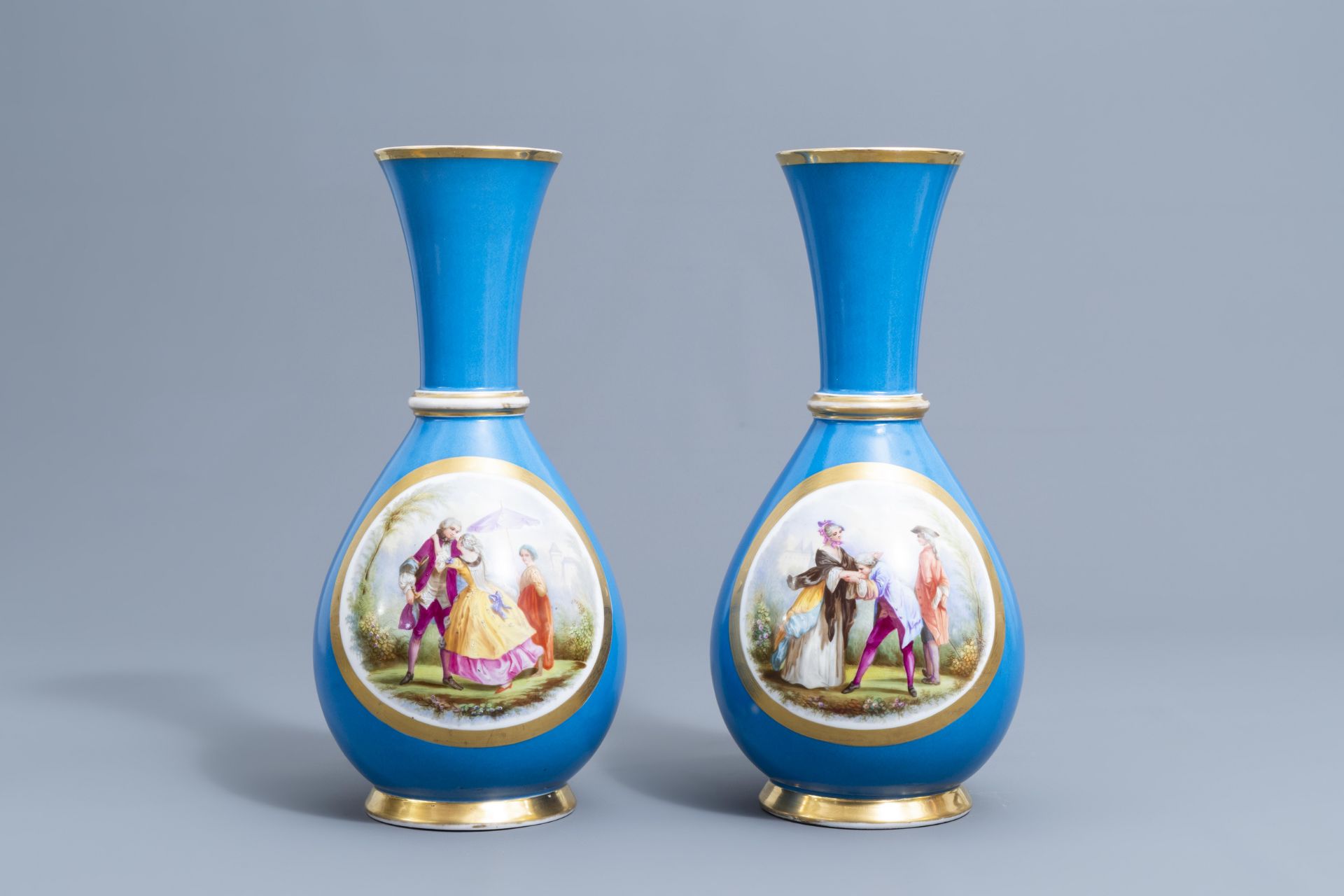 A pair of French 'bleu celeste' ground vases with gallant scenes and a German gilt charger, 20th C. - Image 4 of 24