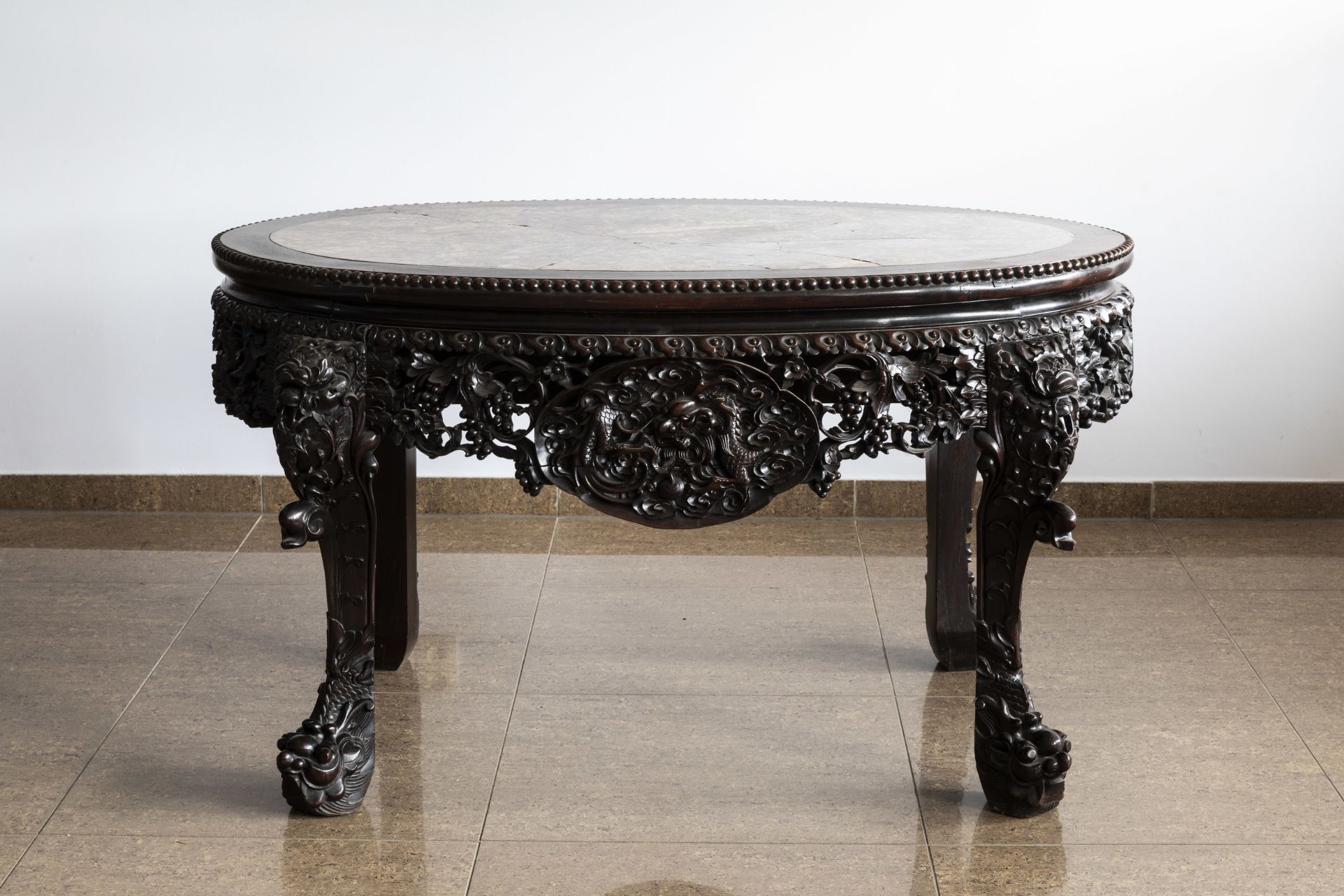 An oval Chinese finely carved wooden table with marble top, 19th C. - Image 2 of 6