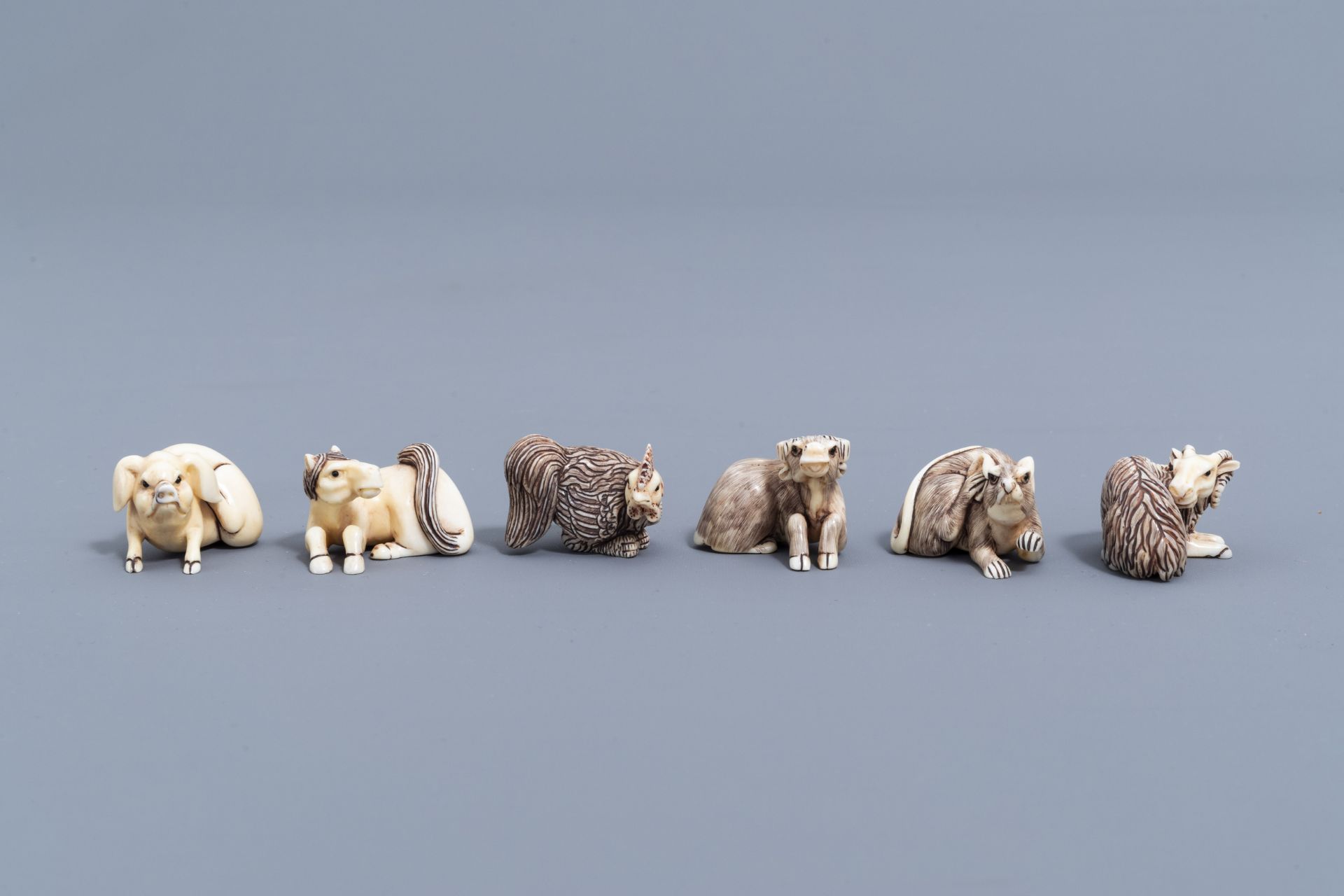 Twelve Japanese animal shaped netsuke in their display cabinet, first half of the 20th C. - Image 15 of 27