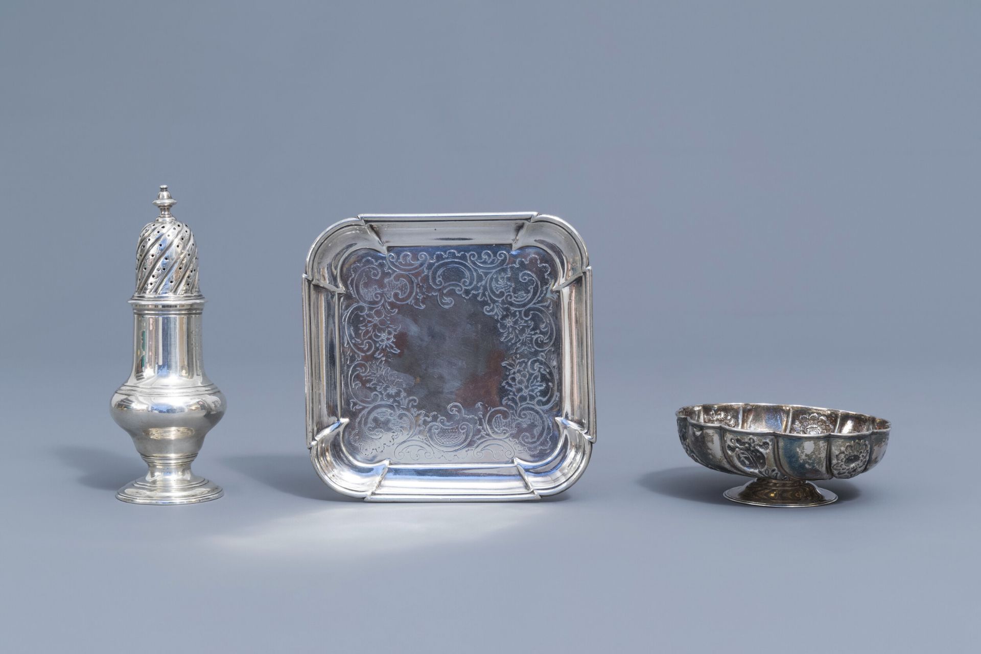 An English silver caster, a bowl on foot and a platter, various marks, 18th/19th C.