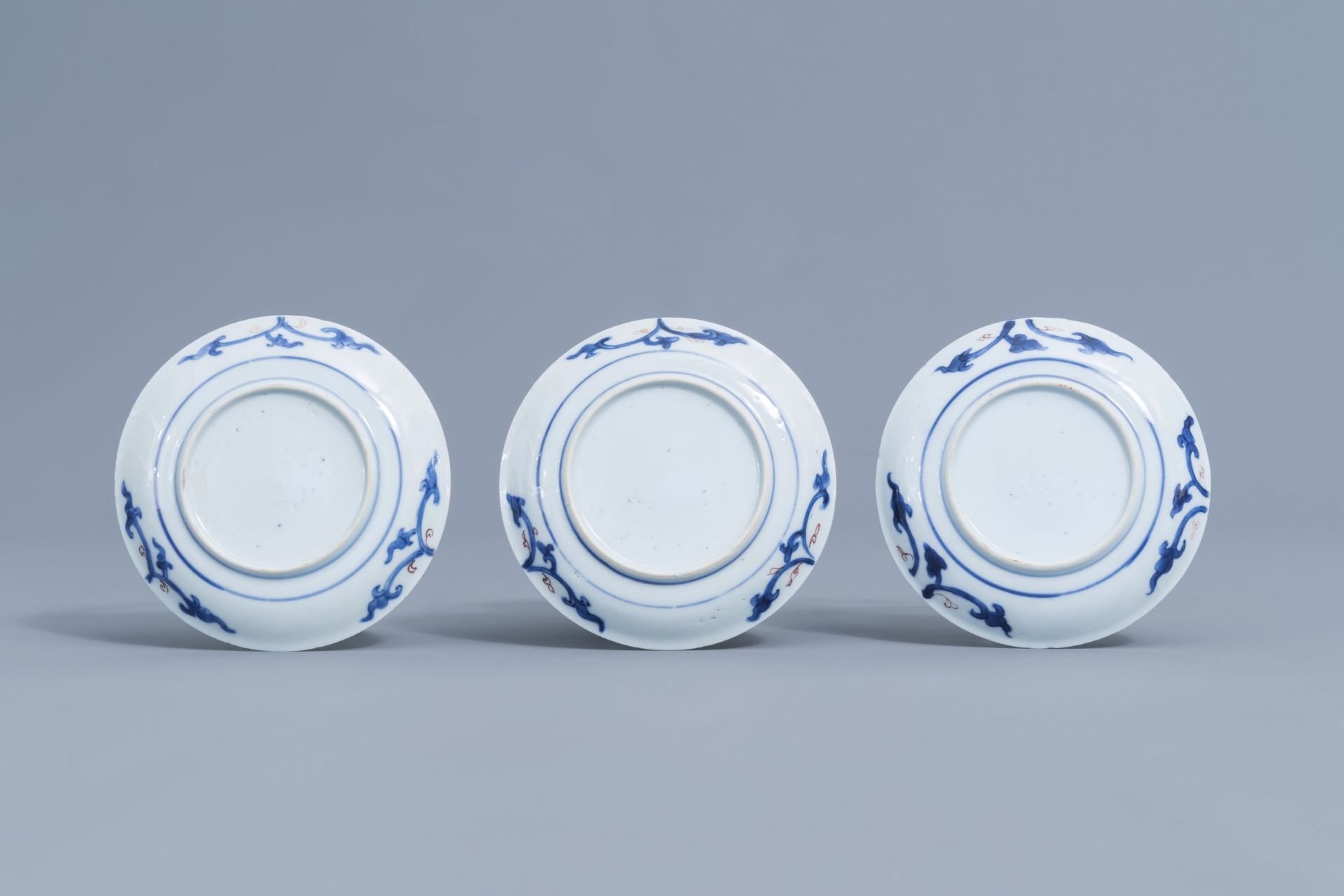 Six Chinese blue, white, iron red and gilt cups and saucers with floral design, Kangxi - Image 9 of 34