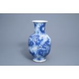 A Chinese blue and white baluster vase with dragons chasing the pearl, 19th C.