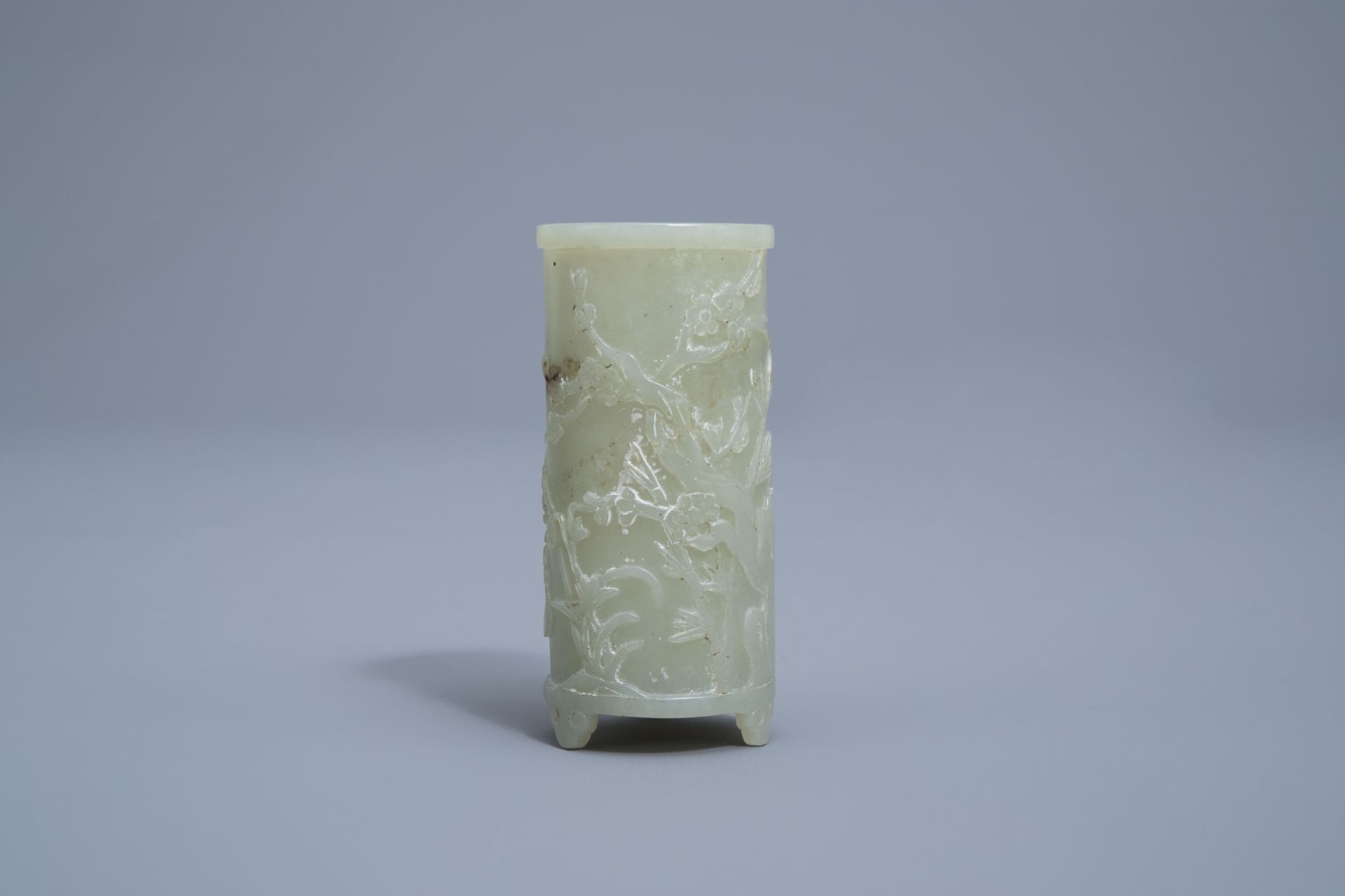 A Chinese celadon jade tripod brush pot with a phoenix among blossoming branches, 19th C. - Image 3 of 4