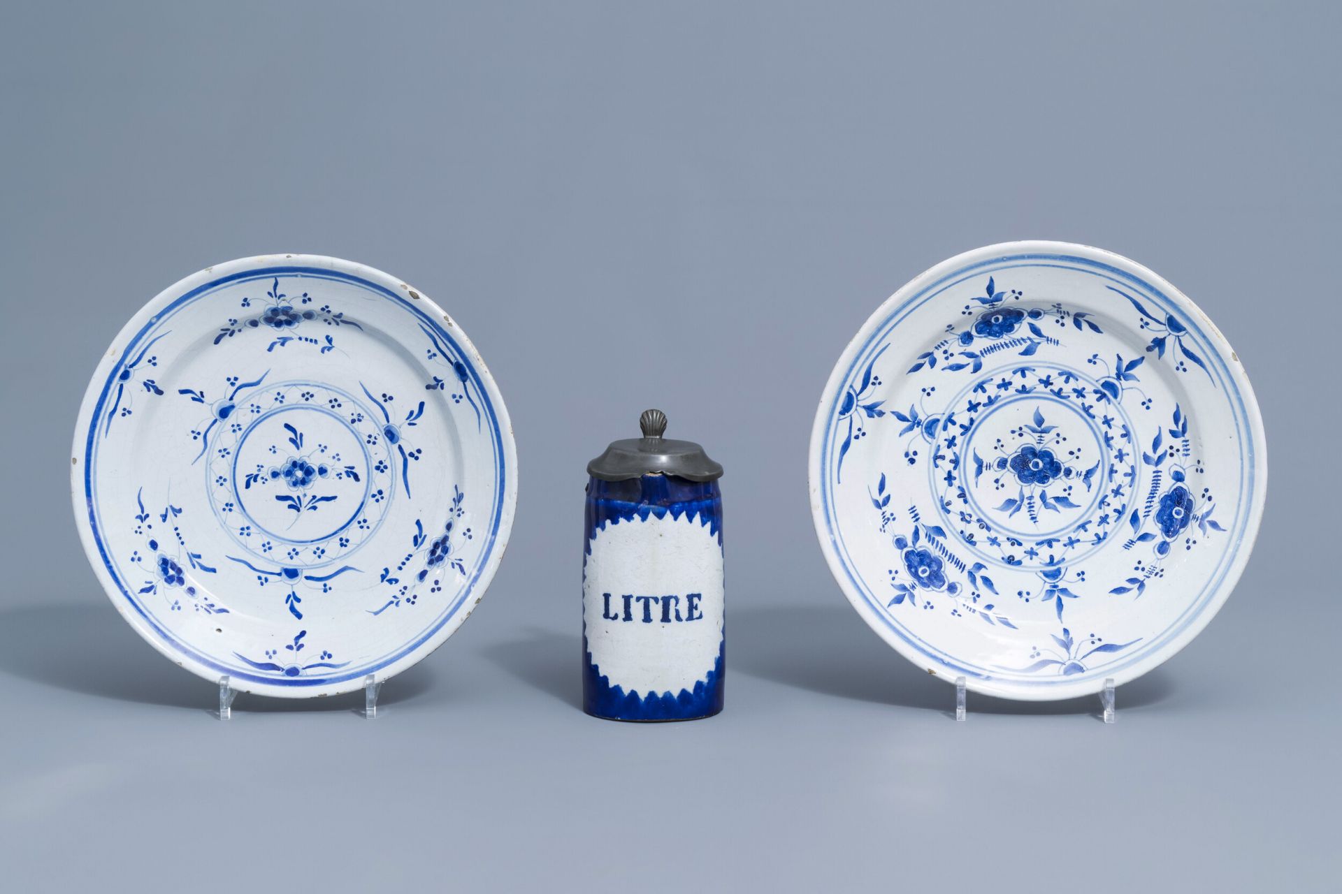 Two blue and white Brussels faience plates and a beer mug, 19th C.