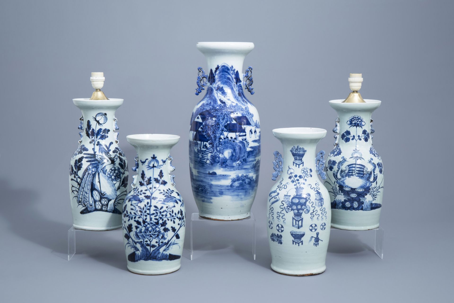 A Chinese blue and white landscape vase and four celadon vases, 19th/20th C.