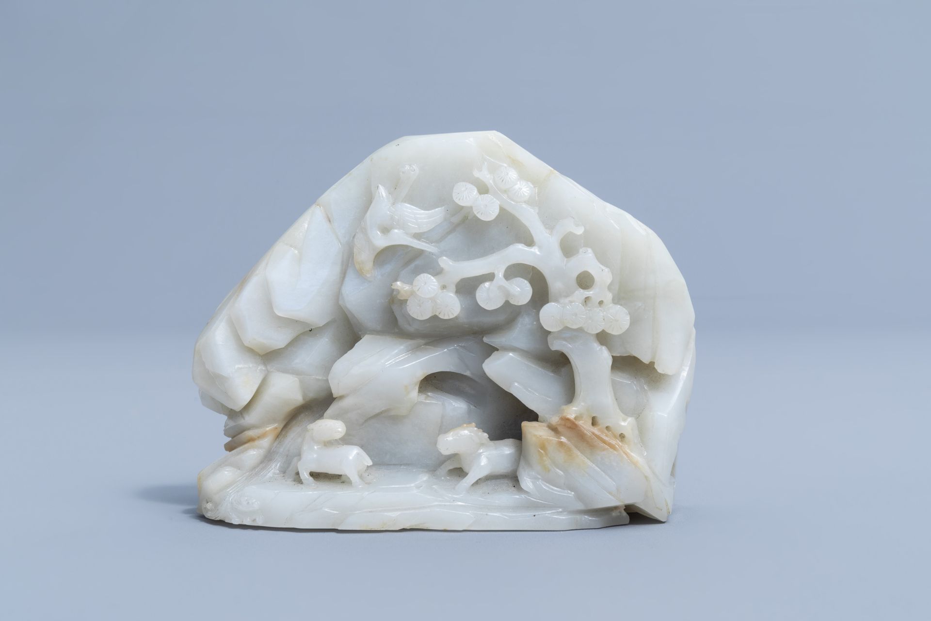 A Chinese double-sided celadon jade boulder with figures in a mountain landscape, 19th/20th C. - Image 4 of 4