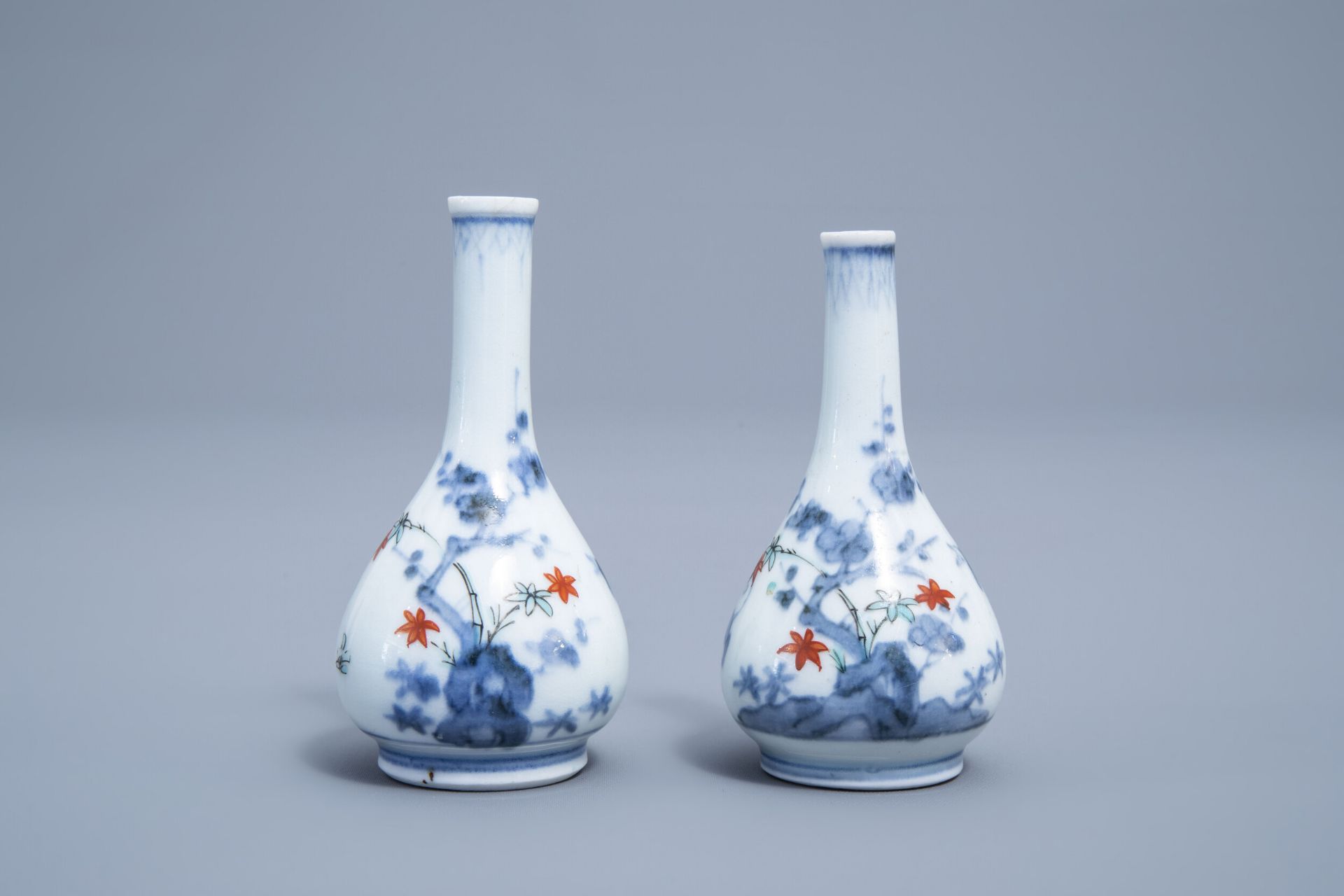 A pair of Japanese Kakiemon doll's house miniature vases with a playing child, Edo, 17th/18th C.