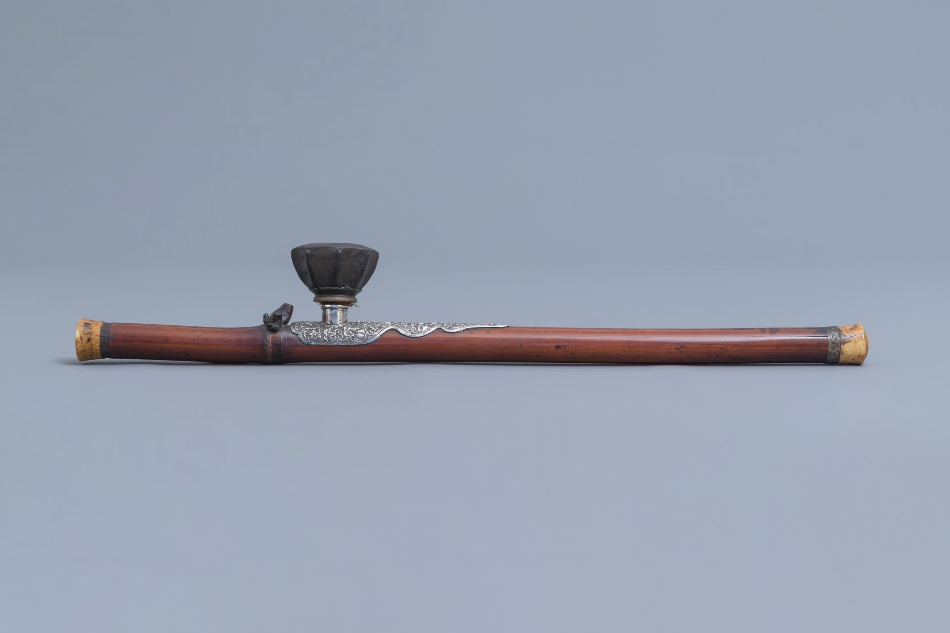 A Chinese bamboo opium pipe with a silver saddle, ivory endpiece and stoneware damper, 19th C. - Image 2 of 12