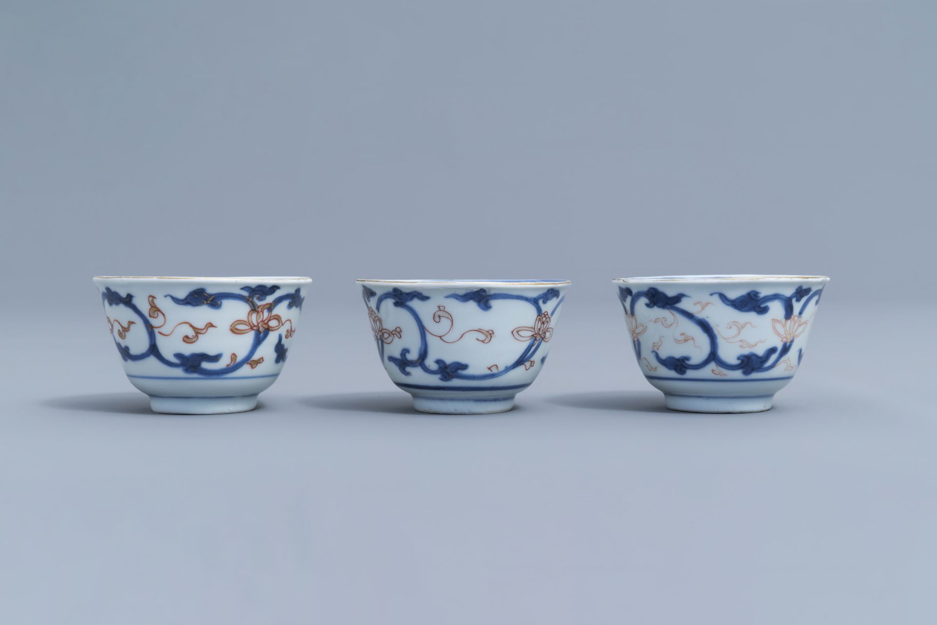 Six Chinese blue, white, iron red and gilt cups and saucers with floral design, Kangxi - Image 30 of 34