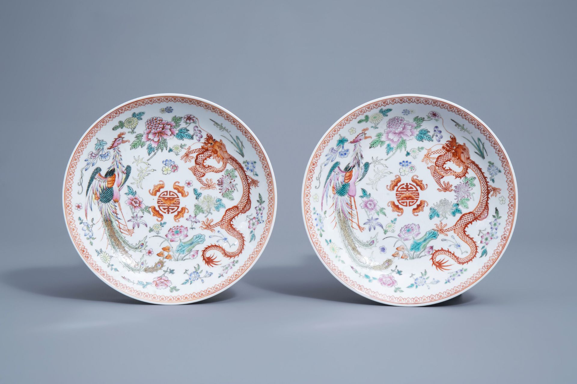 A pair of Chinese famille rose 'dragon and phoenix' chargers, Qianlong mark, 20th C.