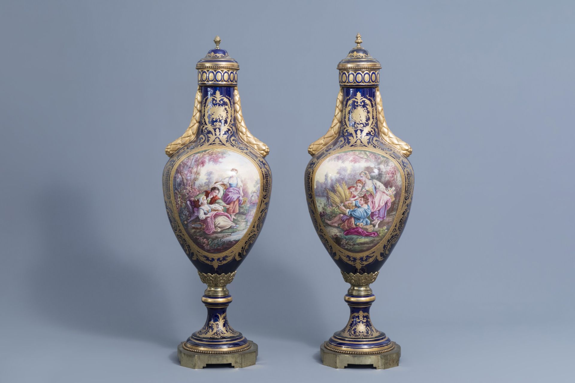 A pair of large French Svres styles vases and covers with gallant scenes and landscapes, 20th C.