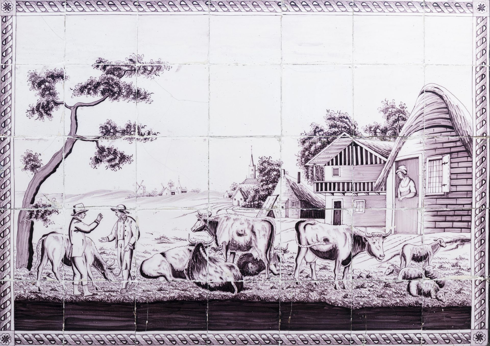 A manganese Dutch Delft tile mural with an animated village view with a cattle dealer, 18th C.