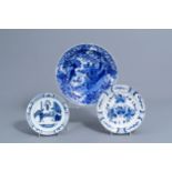 A Dutch Delft blue and white charger and two plates with chinoiserie design, 18th C.