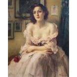 Fernand Toussaint (1873-1956): A young lady with a rose in an interior, oil on canvas