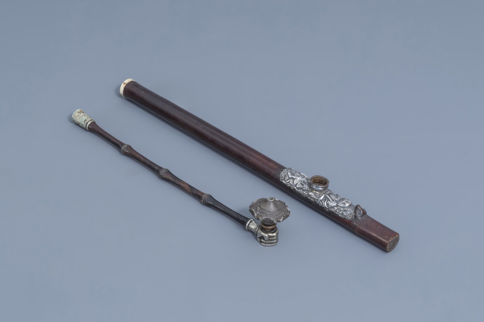 Two Chinese bamboo opium pipes finished with silver, jade, ivory and stoneware, 19th C.