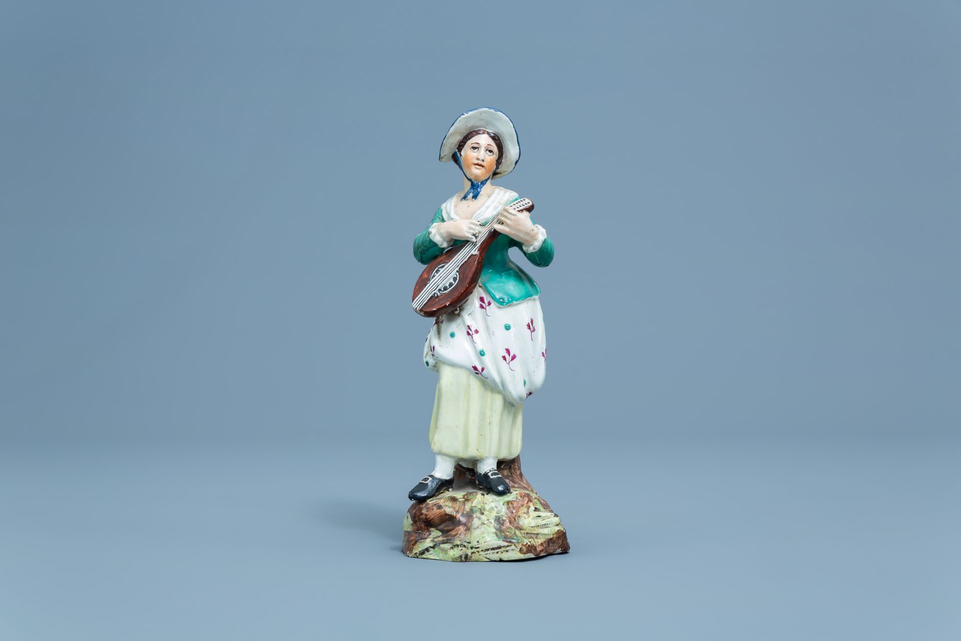 A German polychrome decorated earthenware figure of a lady with a mandolin, Hšchst, 18th C. - Image 2 of 7