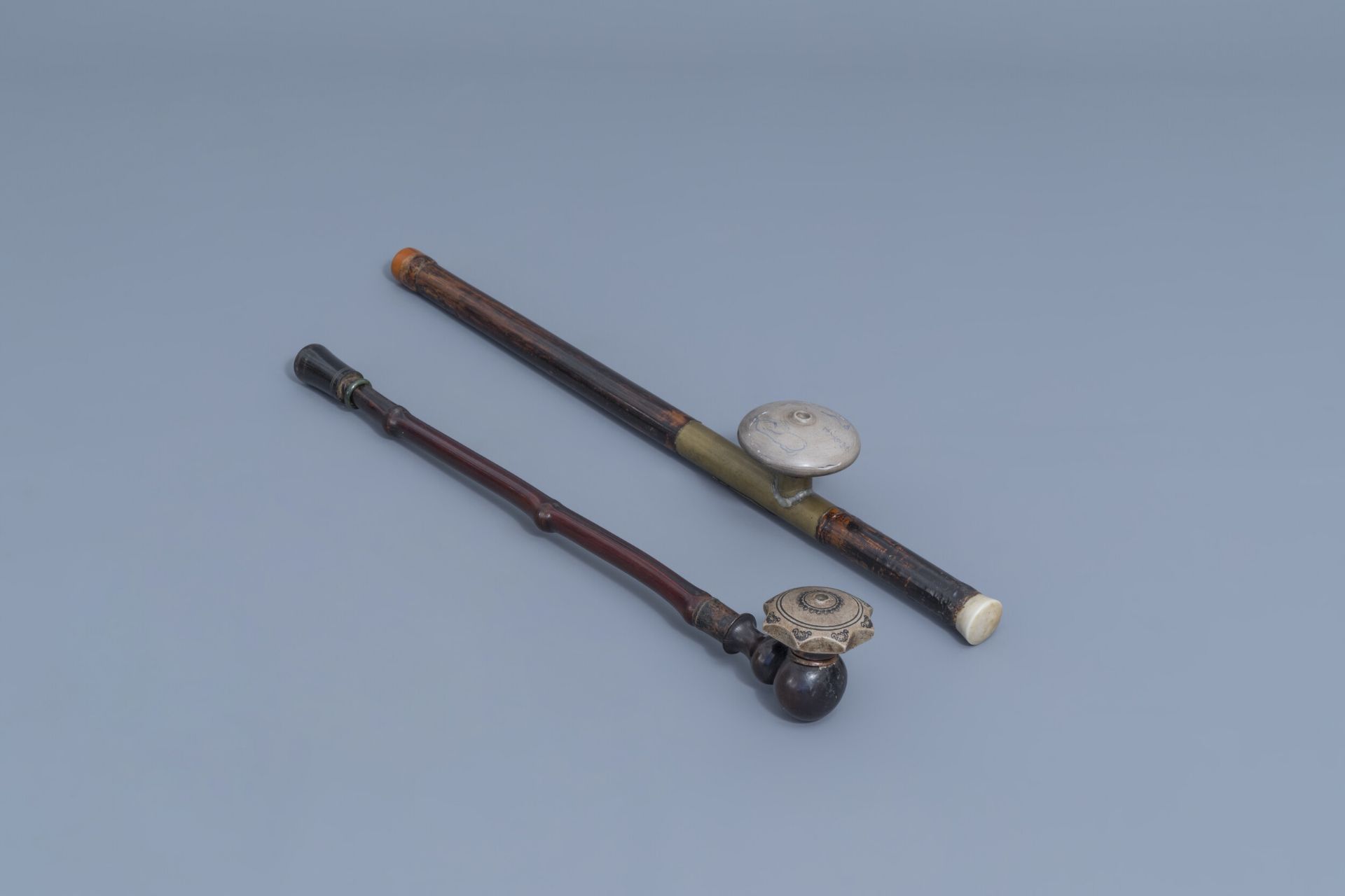 Two Chinese bamboo opium pipes finished with brass, jade, ivory and stoneware, ca. 1900