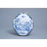 A Dutch Delft blue and white plaque with a galant scene, 18th C.