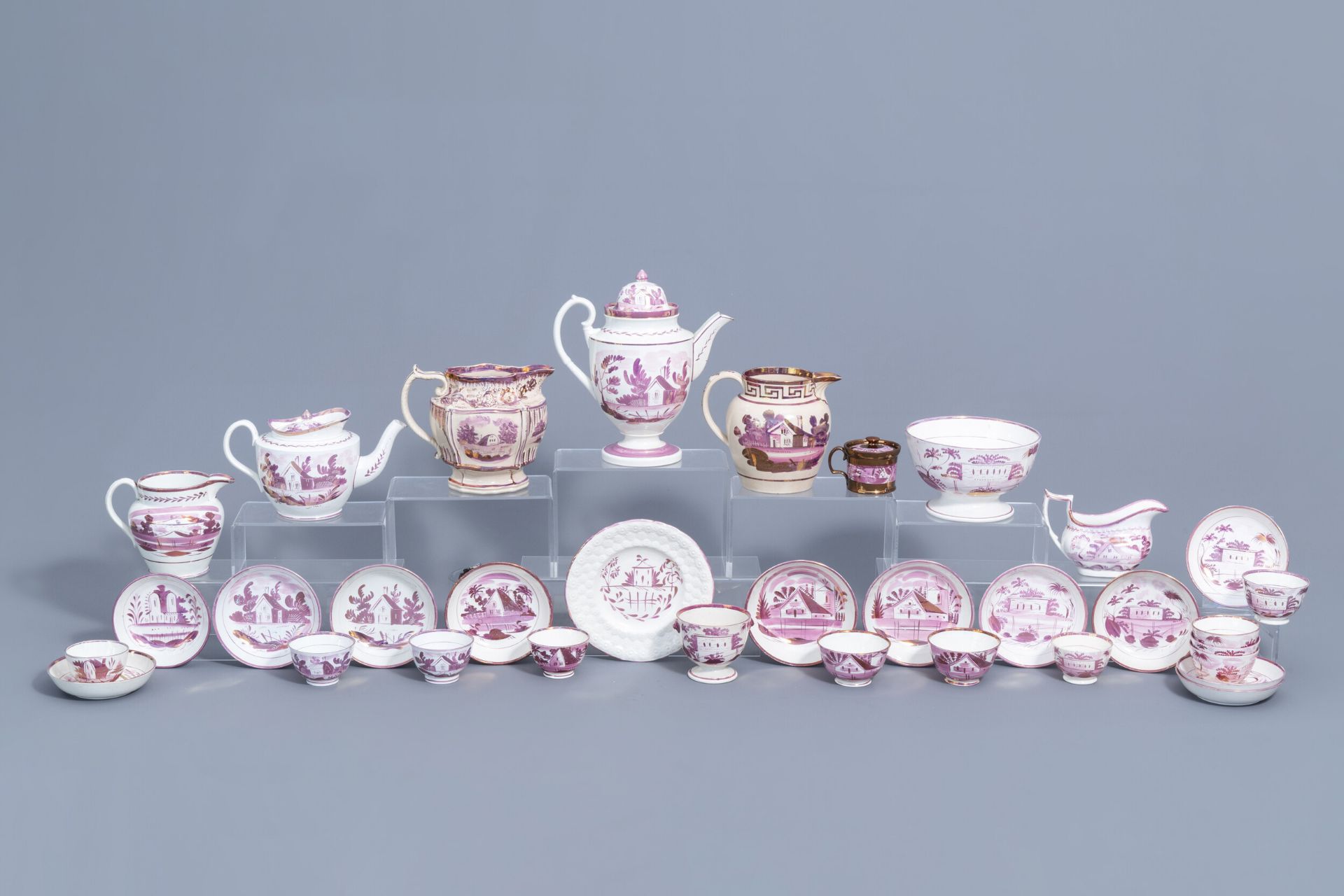 A varied collection of English pink lustreware items with a cottage in a landscape, 19th C.