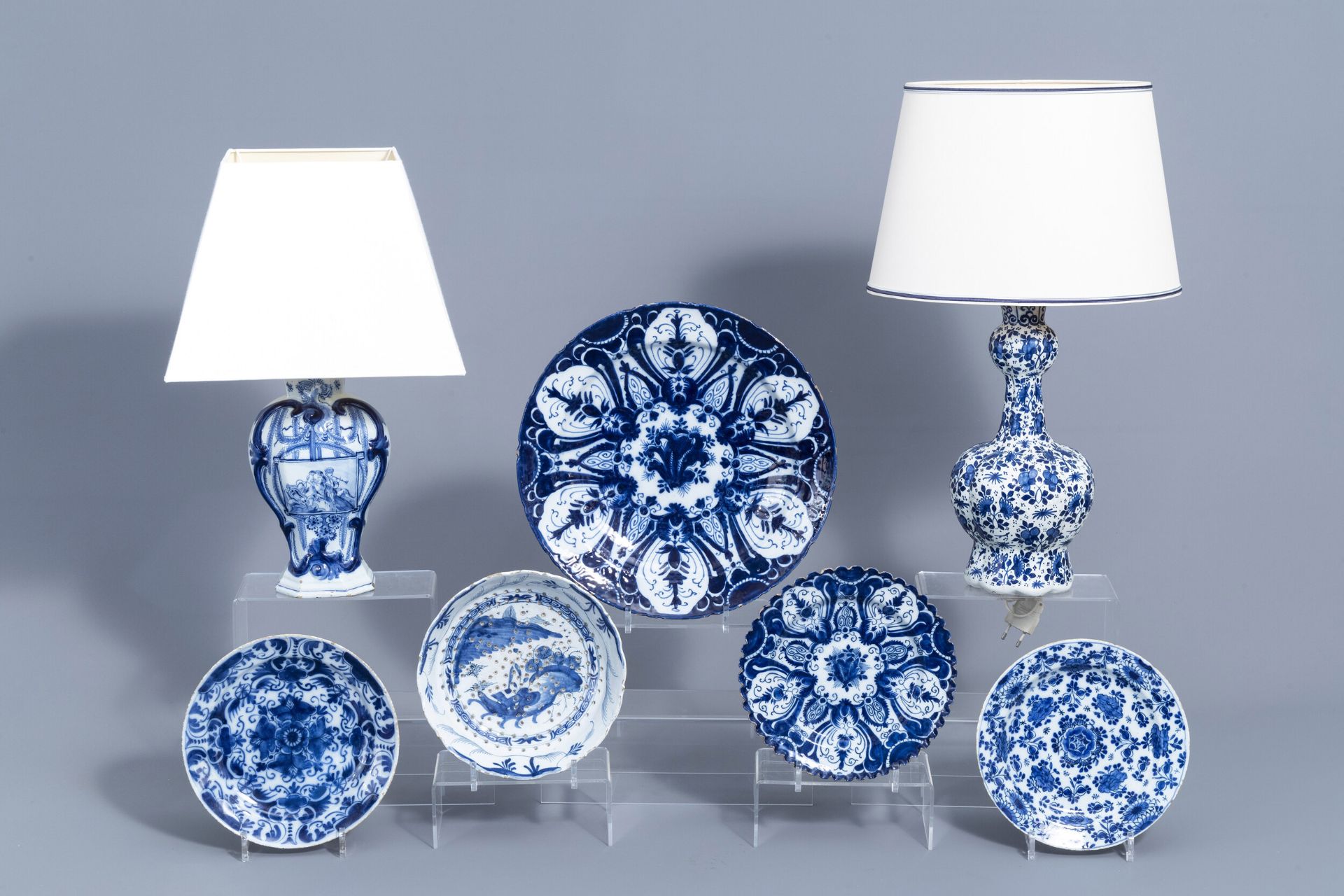 A varied collection of Dutch Delft blue and white pottery with mosty floral designs, 18th C.
