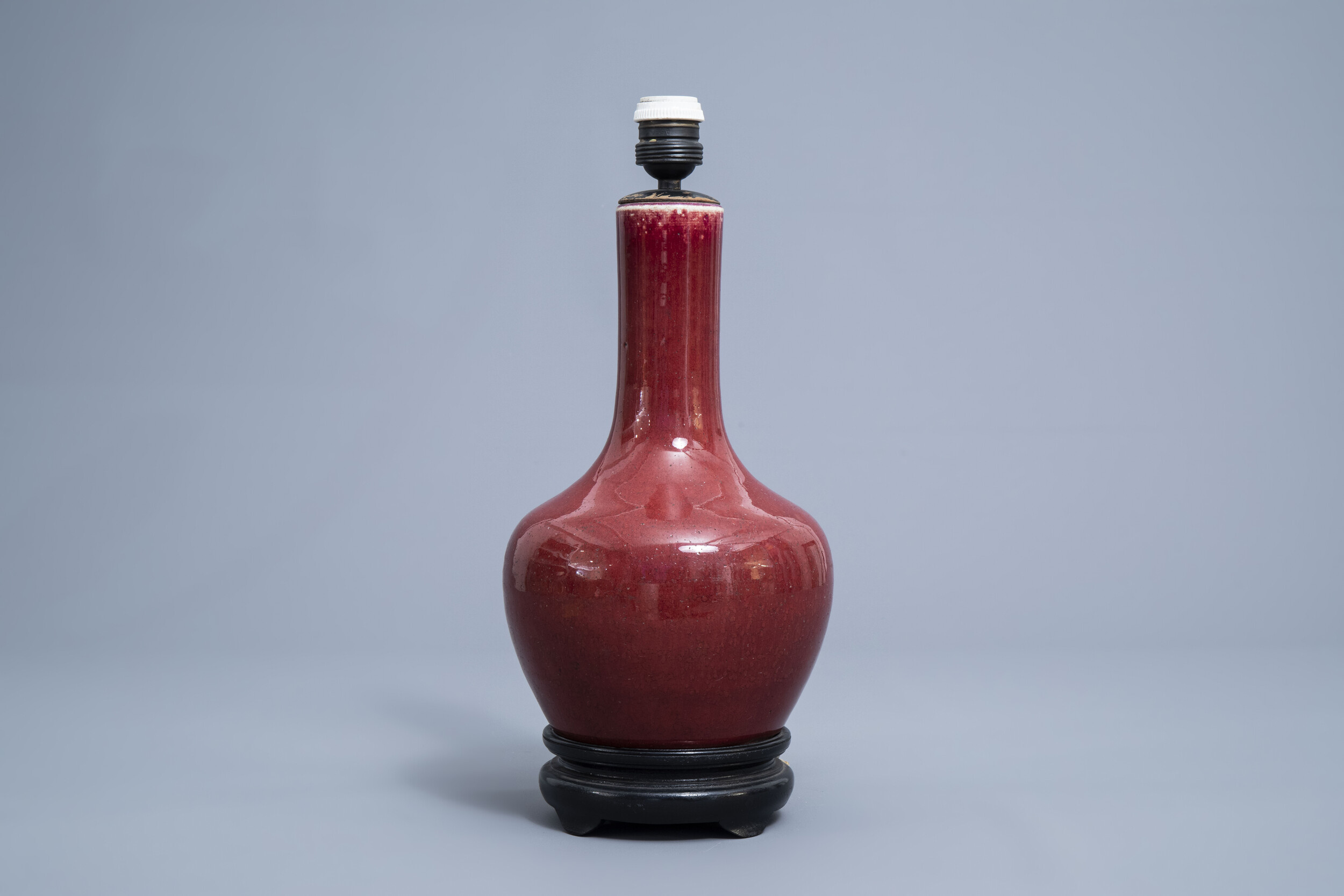 A Chinese monochrome sang de boeuf lamp-mounted bottle vase, 19th C.