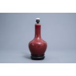 A Chinese monochrome sang de boeuf lamp-mounted bottle vase, 19th C.