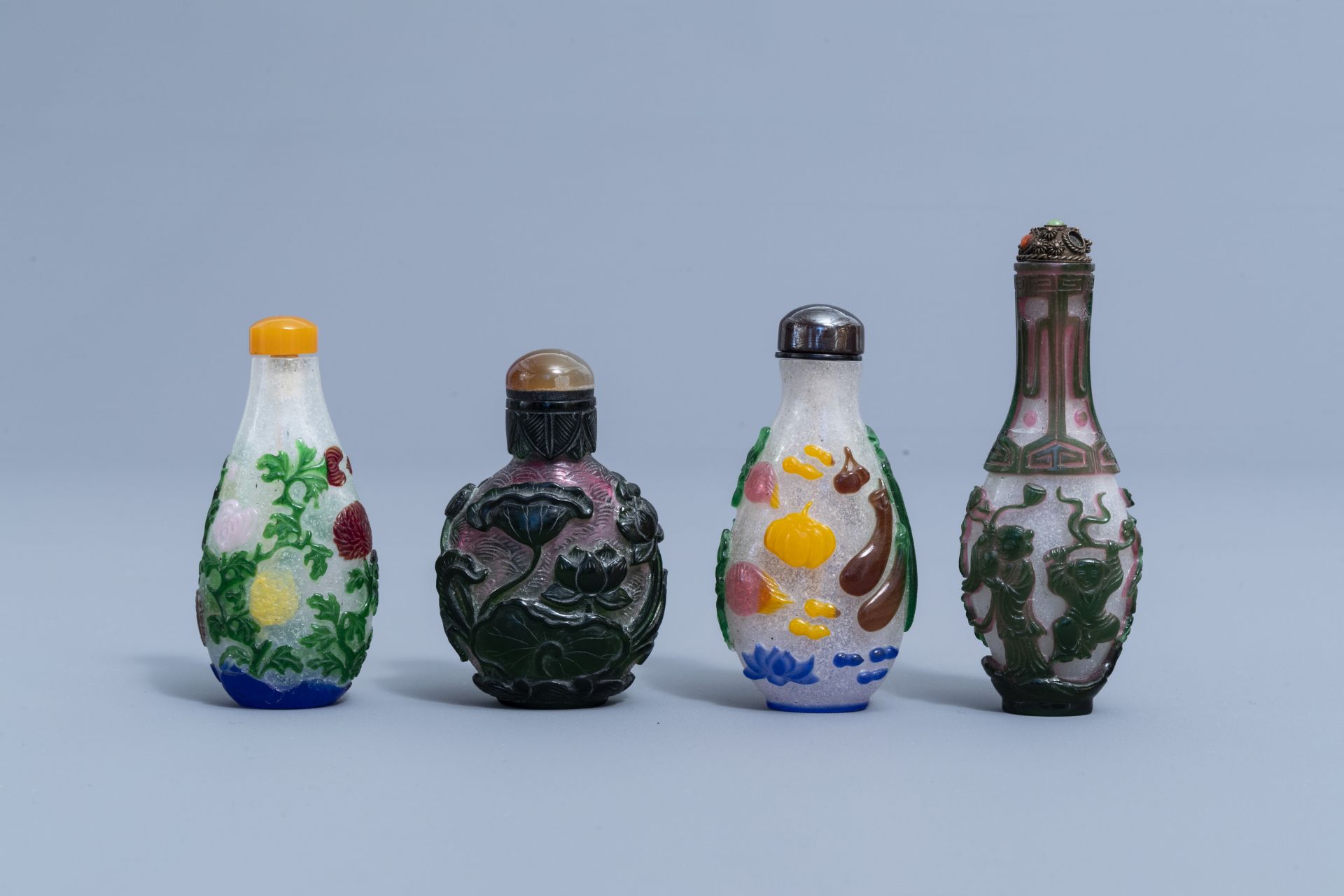 Eight Chinese multi-colour overlay glass snuff bottles, 20th C.