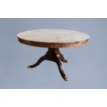 A circular English Regency mahogany tripod breakfast table wit a star veneered top, ca. 1810