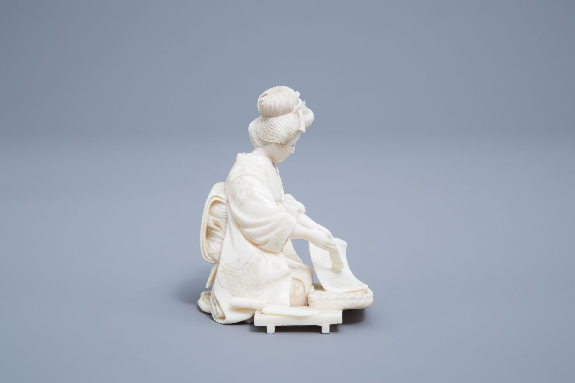 A signed Japanese ivory ikomono of a lady at work, Meiji, 19th/20th C. - Image 3 of 8