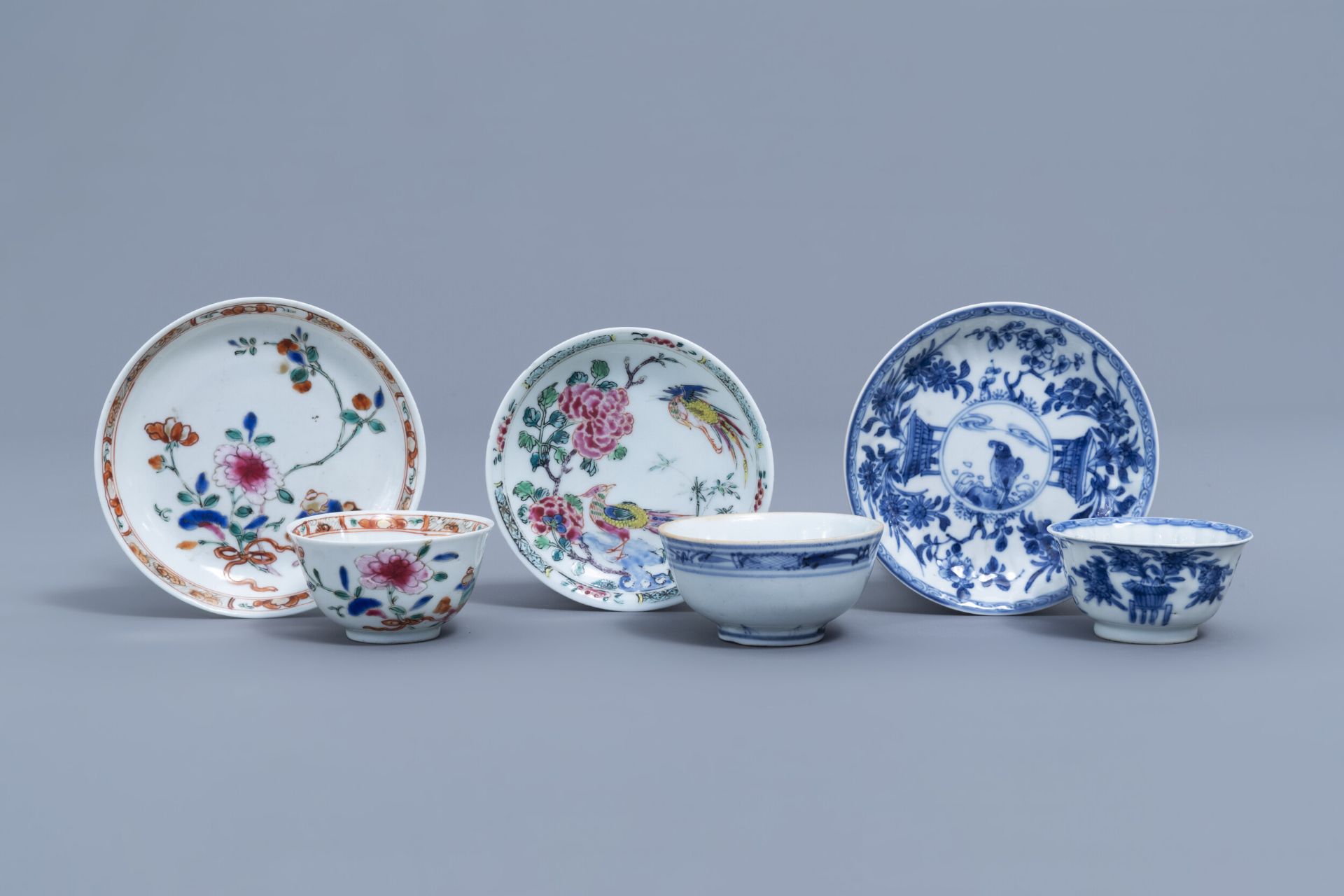 Three Chinese blue, white and famille rose cups and three saucers, Kangxi and later