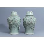 A pair of large Chinese celadon crackle glazed vases and covers with floral relief design, 20th C.