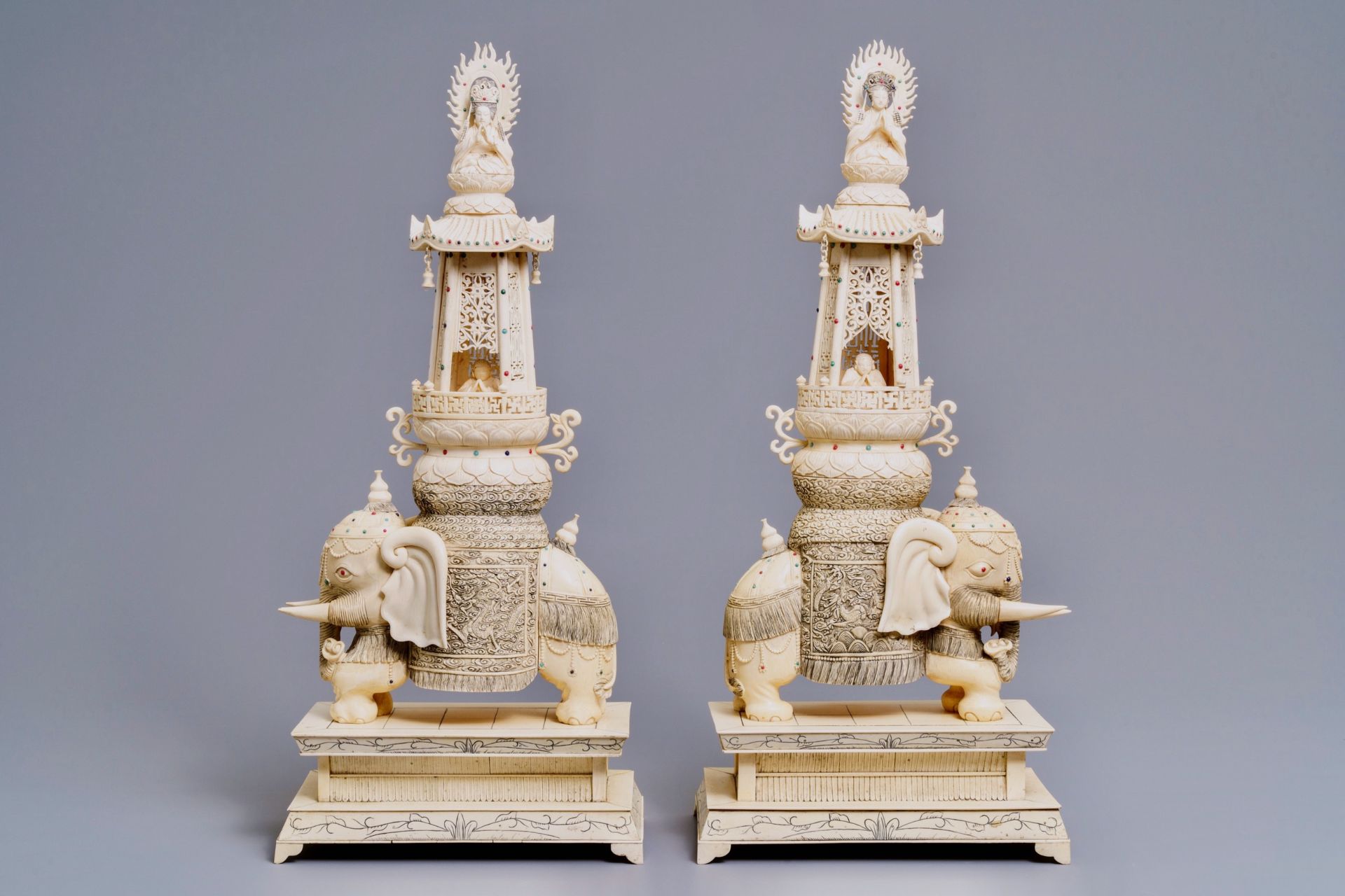 A pair of large inlaid Chinese ivory groups of Buddha and Guanyin on an elephant, 19th C.