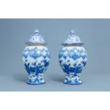 A pair of Dutch Delft blue and white 'chinoiserie' vases and covers, 18th C.