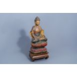 A Chinese polychrome painted wooden figure of Buddha on a lotus throne on a wooden base, 20th C.