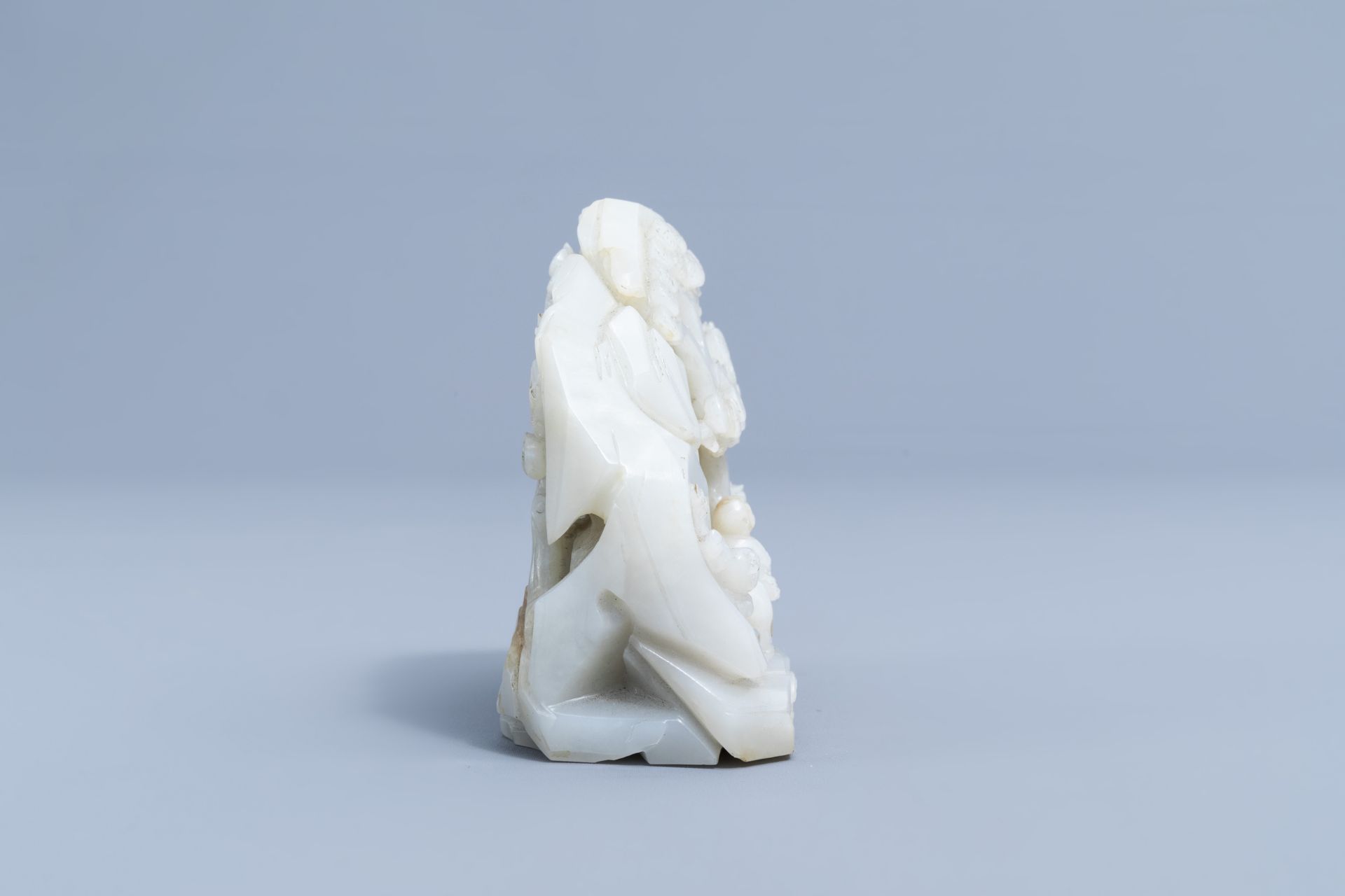 A Chinese double-sided celadon jade boulder with figures in a mountain landscape, 19th/20th C. - Image 3 of 4