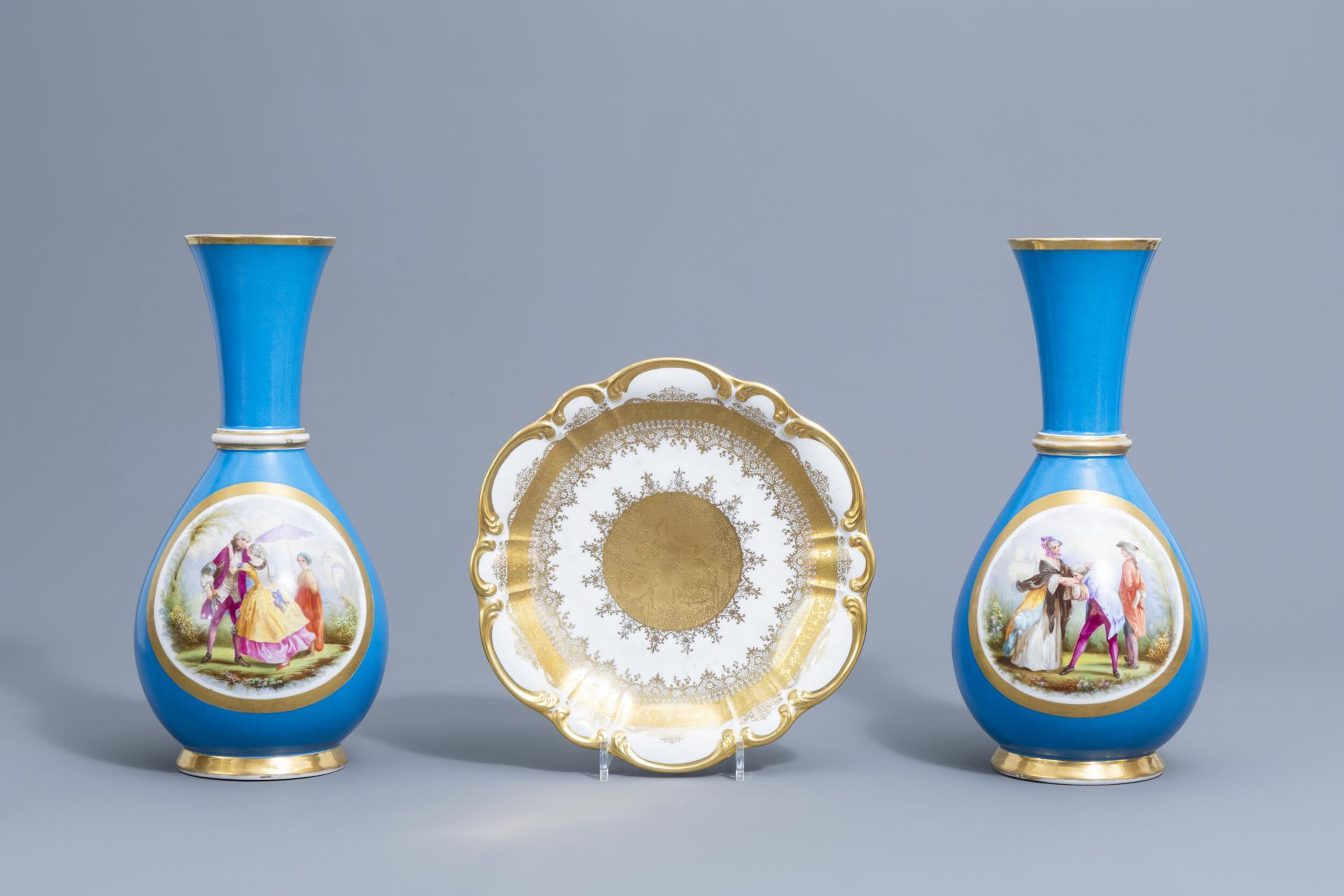A pair of French 'bleu celeste' ground vases with gallant scenes and a German gilt charger, 20th C. - Image 2 of 24