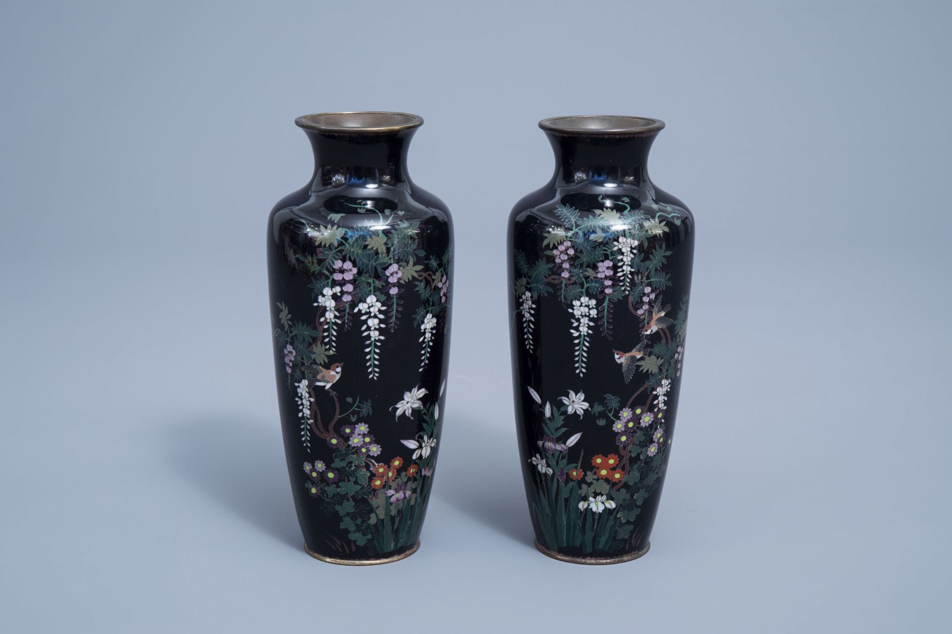 A pair of fine Japanese cloisonne vases with a bird among blossoming branches, Meiji, 19th C.