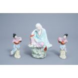 A Chinese famille rose figure of Buddha and a pair of ladies with peaches, 20th C.