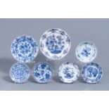 Two Dutch Delft blue and white chargers and five plates with floral design, 18th C.